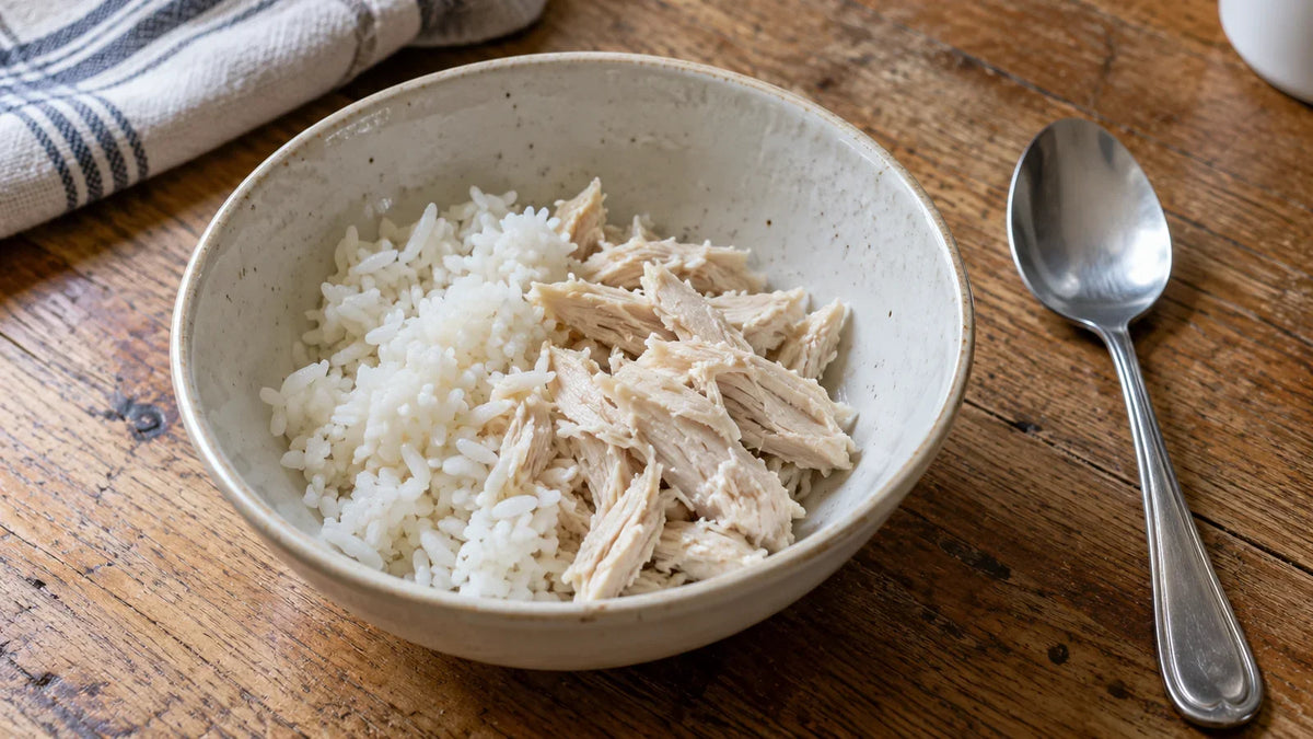 Plain white rice and shredded chicken in a ceramic bowl