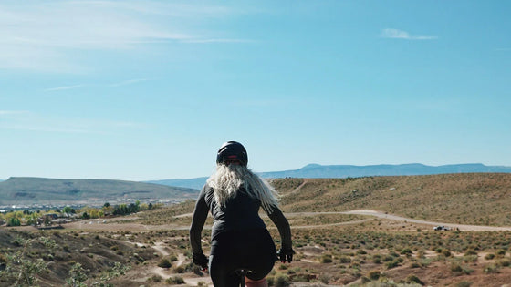 Dog walking on a path beside a bicycle