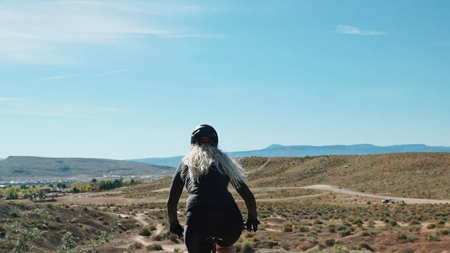 Dog walking on a path beside a bicycle